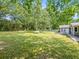 Beautiful backyard offering a spacious lawn with scattered trees, perfect for outdoor gatherings and relaxation at 30 Court S, Ellenwood, GA 30294