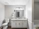 Bathroom with a white vanity, granite countertop, and a decorative mirror at 30 Court S, Ellenwood, GA 30294