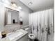 Bathroom featuring a granite countertop vanity, white sink, and shower with curtain at 30 Court S, Ellenwood, GA 30294