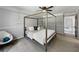 Comfortable bedroom featuring a canopy bed, chair, and neutral decor at 30 Court S, Ellenwood, GA 30294