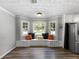 Dining area featuring a cozy window seat with decorative pillows and built-in storage at 30 Court S, Ellenwood, GA 30294