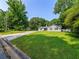 Traditional home with a large front lawn and mature trees offering plenty of shade at 30 Court S, Ellenwood, GA 30294