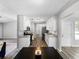 Bright kitchen featuring white cabinets, granite countertops, stainless steel appliances, and hardwood floors at 30 Court S, Ellenwood, GA 30294