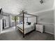Serene main bedroom featuring a four-poster bed, neutral décor, and a bright atmosphere at 30 Court S, Ellenwood, GA 30294