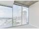Bright bedroom featuring light colored carpet and large windows with city views and balcony access at 3324 Peachtree Ne Rd # 1604, Atlanta, GA 30326