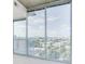 Cozy bedroom featuring light colored carpet and large windows with city views and balcony access at 3324 Peachtree Ne Rd # 1604, Atlanta, GA 30326