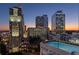 Stunning city view with pool and modern high rise buildings at dusk, perfect for urban living at 3324 Peachtree Ne Rd # 1604, Atlanta, GA 30326