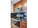 Updated kitchen featuring stainless steel appliances, microwave, and dark tile backsplash at 3324 Peachtree Ne Rd # 1604, Atlanta, GA 30326