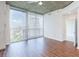 Bright living room featuring wood floors, a ceiling fan, and large windows with city views at 3324 Peachtree Ne Rd # 1604, Atlanta, GA 30326