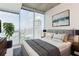 Cozy main bedroom with large windows offering city views, featuring modern decor and plush bedding at 3324 Peachtree Ne Rd # 1604, Atlanta, GA 30326