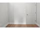 Image of an unfinished basement area with tan wood-look flooring and a white door at 4778 Moonstone Trce, Kennesaw, GA 30144