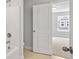 Bathroom doorway view to bedroom with carpet, window, and single-Gathering residence view at 4778 Moonstone Trce, Kennesaw, GA 30144