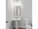 Bathroom featuring a pedestal sink, modern lighting, and a classic toilet design at 4778 Moonstone Trce, Kennesaw, GA 30144