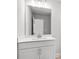 Bathroom vanity with a large mirror, white cabinets, and modern faucet fixtures at 4778 Moonstone Trce, Kennesaw, GA 30144