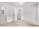 Light-filled bedroom with neutral walls and carpet, showcasing open doorway and modern fixtures at 4778 Moonstone Trce, Kennesaw, GA 30144