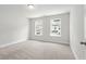 Bedroom featuring two windows, neutral carpet and grey painted walls at 4778 Moonstone Trce, Kennesaw, GA 30144