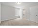 Bedroom featuring neutral carpet and an ensuite bathroom with white doors at 4778 Moonstone Trce, Kennesaw, GA 30144