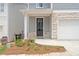 Close-up of front entrance with stone accents, a black front door, and fresh landscaping at 4778 Moonstone Trce, Kennesaw, GA 30144