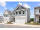 Beautifully designed two-story home with gray siding, stone details, and an attached garage at 4778 Moonstone Trce, Kennesaw, GA 30144
