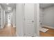 Hallway with access to laundry room featuring a washing machine and a wire shelf at 4778 Moonstone Trce, Kennesaw, GA 30144