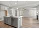 Modern kitchen featuring an island with sink, stainless dishwasher, and view to the living room at 4778 Moonstone Trce, Kennesaw, GA 30144