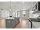 Bright, open kitchen with gray cabinets, quartz countertops and modern appliances overlooking the living room at 4778 Moonstone Trce, Kennesaw, GA 30144