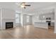 Open-concept living room flows into the kitchen with views of modern fireplace and island at 4778 Moonstone Trce, Kennesaw, GA 30144