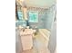 Retro-style bathroom with blue tile, patterned wallpaper, and checkered tile floor at 813 Crockett Ct, Decatur, GA 30033