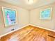 Bedroom showcasing neutral walls, hardwood floors, and natural light from the two windows at 813 Crockett Ct, Decatur, GA 30033
