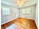 This bedroom features a ceiling fan, hardwood floors, and two bright windows at 813 Crockett Ct, Decatur, GA 30033