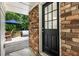 Brick back porch featuring a patio table and umbrella at 2163 Medfield Ne Trl, Chamblee, GA 30345