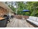 Backyard deck featuring patio furniture, a grill, and a blue umbrella at 2163 Medfield Ne Trl, Chamblee, GA 30345