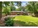 Spacious backyard with a deck, lush green grass, and mature trees at 2163 Medfield Ne Trl, Chamblee, GA 30345