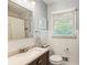 Bright bathroom with a new vanity, framed mirror, white subway tiles, and white paneled walls at 2163 Medfield Ne Trl, Chamblee, GA 30345