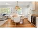 Bright dining area features hardwood floors, cozy seating, and a unique woven pendant light fixture at 2163 Medfield Ne Trl, Chamblee, GA 30345