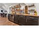 Finished basement bar with a wine fridge, wood countertop, open shelving, and barware at 540 Byrd Mountain Ln, Canton, GA 30114