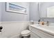Powder room with blue wallpaper, white wainscoting, and modern fixtures; sophisticated and stylish at 540 Byrd Mountain Ln, Canton, GA 30114