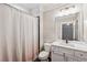 A bathroom with a white vanity, mirror, and a shower with a patterned curtain at 540 Byrd Mountain Ln, Canton, GA 30114