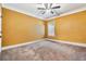 A simple bedroom with yellow walls, carpet, and a window at 540 Byrd Mountain Ln, Canton, GA 30114