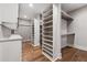 Walk-in closet with built-in white shelving and hardwood floors, perfect for organization and storage at 540 Byrd Mountain Ln, Canton, GA 30114