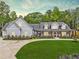 Beautifully landscaped home with a rocking chair front porch and lush green lawn at 540 Byrd Mountain Ln, Canton, GA 30114