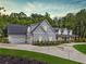 Stately home featuring an attached three car garage and manicured lawn at 540 Byrd Mountain Ln, Canton, GA 30114