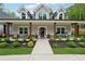 Inviting front porch with seating and a beautifully landscaped garden at 540 Byrd Mountain Ln, Canton, GA 30114