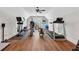 Bright home gym with wood floors, ceiling fan, and various exercise equipment at 540 Byrd Mountain Ln, Canton, GA 30114