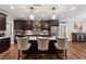 Gourmet kitchen featuring an island with seating, modern appliances, and beautiful hardwood floors at 540 Byrd Mountain Ln, Canton, GA 30114