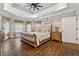 Bright main bedroom featuring a tray ceiling and hardwood floors at 540 Byrd Mountain Ln, Canton, GA 30114