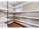 Walk-in pantry featuring custom shelving, recessed lighting, and hardwood floors at 540 Byrd Mountain Ln, Canton, GA 30114
