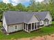 A gray home features a screened-in porch, an outdoor dining area, and a well maintained lawn at 540 Byrd Mountain Ln, Canton, GA 30114