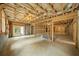 Unfinished basement with exposed ceiling, concrete walls, framing, and a walkout to the backyard at 6175 River Shore Pkwy, Atlanta, GA 30328
