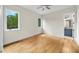 Sun-filled bedroom with hardwood floors, two windows, and access to an en-suite bathroom at 6175 River Shore Pkwy, Atlanta, GA 30328